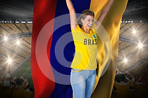 Excited football fan in brasil tshirt holding colombia flag