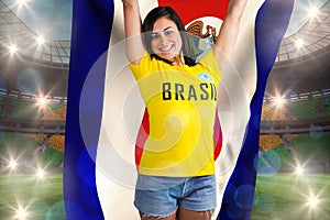 Excited football fan in brasil tshirt holding costa rica flag