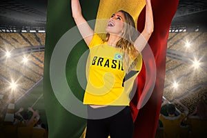 Excited football fan in brasil tshirt holding ghana flag