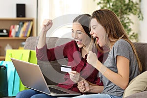 Excited friends buying online with credit card