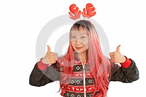 excited funny Asian girl in a Christmas reindeer antlers pointing up smiling isolated on white background