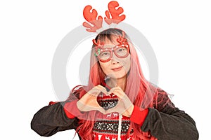 excited funny Asian girl in a Christmas reindeer antlers pointing up smiling isolated on white background