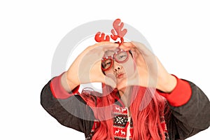 excited funny Asian girl in a Christmas reindeer antlers pointing up smiling isolated on white background