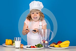 Excited funny chef cook. Child chef  on blue. Funny little kid chef cook wearing uniform cook cap and apron