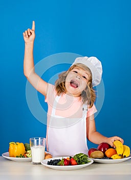 Excited funny chef cook. Child chef dressed cook baker apron and chef hat isolated on studio background. Healthy