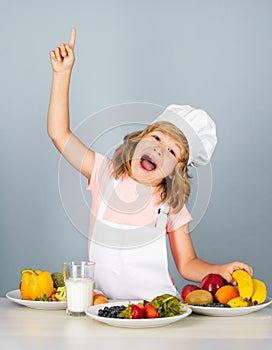 Excited funny chef cook. Child chef isolated on blue. Funny little kid chef cook wearing uniform cook cap and apron