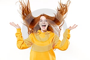 Excited funny young redhead woman girl in yellow hoodie posing isolated on white wall background studio portrait. People