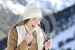 Excited girl checking online news in winter