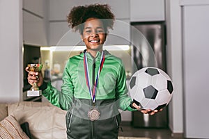 Girl with medals and trophy cup