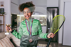 Girl with medals and trophy cup