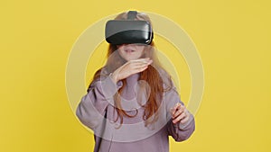 Excited girl in VR headset helmet watching virtual reality 3D video, playing simulation online game