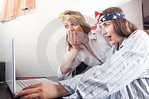 Excited girlfriends surfing the internet