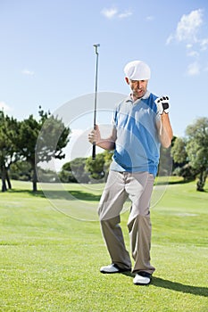 Excited golfer cheering on putting green
