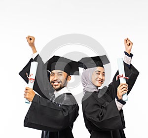 Excited graduate boy and girl in toga holding certificates