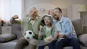 Excited grandpa, dad and son happy for national football team winning game, home