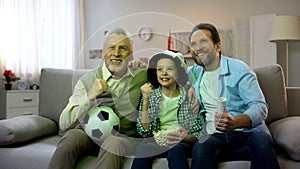 Excited grandpa, dad and son happy for national football team winning game, home
