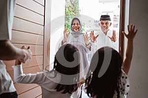 excited grandparents visiting their grandchildren