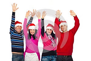 Excited group of friends with Santa hats