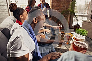 Excited group of people watching football, sport match at home