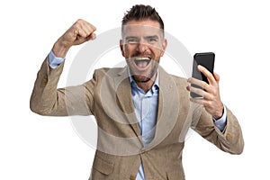 Excited guy with undone shirt celebrating the victory with arms up