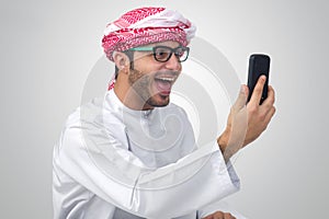 Excited, handsome Arab man expressing success