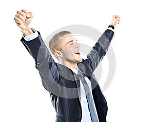 Excited handsome business man with arms raised in success