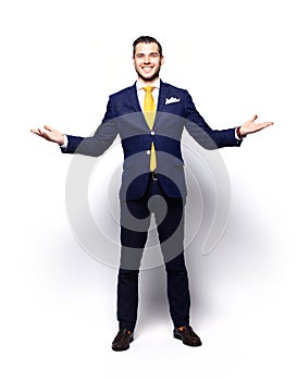 Excited handsome business man with arms raised in success