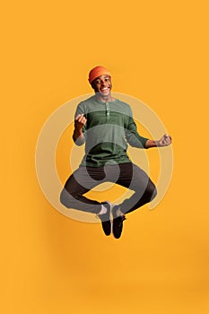 Excited Happy African American Guy Celebrating Success While Jumping In Air