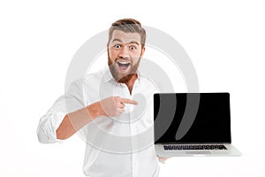 Excited happy bearded man pointing finger