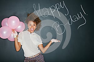 Excited, happy birthday balloons and portrait of a model and chalkboard for celebration. Happy, smile and excited person