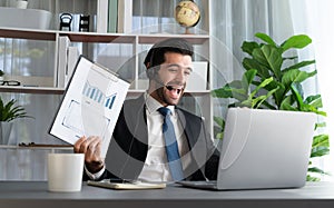 Excited and happy businessman dressed in black formal suit. Fervent