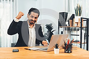 Excited and happy businessman dressed in black formal suit. Fervent