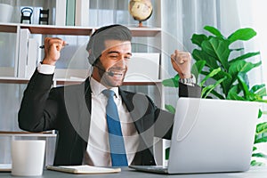 Excited and happy businessman dressed in black formal suit. Fervent