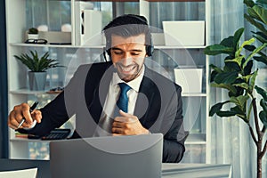 Excited and happy businessman dressed in black formal suit. Fervent