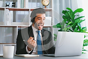 Excited and happy businessman dressed in black formal suit. Fervent