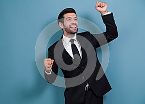 Excited and happy businessman dressed in black formal suit. Fervent