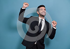 Excited and happy businessman dressed in black formal suit. Fervent