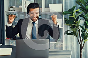 Excited and happy businessman dressed in black formal suit. Fervent