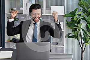 Excited and happy businessman dressed in black formal suit. Fervent