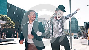 Excited, happy and businessman with mime outdoor in city, business park and skipping for friendship in urban setting