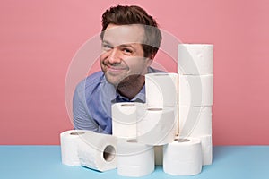 Excited happy caucasian man holding a pile of toilet paper showing thumb up