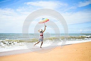 Excited happy female having fun on beach walk on sunny outdoors background