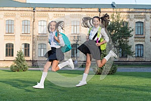 Excited happy girls school uniform running, hurry up concept