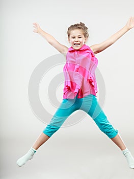 Excited happy little girl kid jumping for joy.