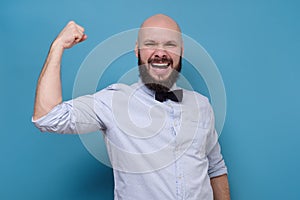Excited happy man holding fists up being glad with his success