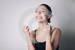 Excited happy woman saying yes I done it raising her fists being surprised not expecting her triumph. photo