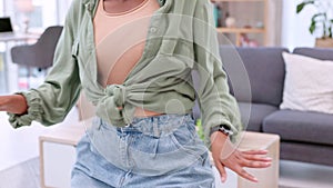 Excited, happy young woman cleaning, dancing and having fun alone in her living room at home. Closeup of a casual female