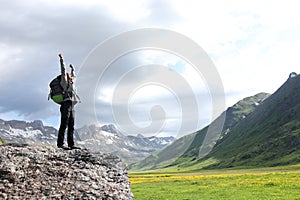 Excited hiker celebrating raising arms