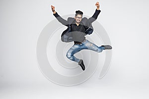Excited Indian businessman jumping for joy isolated on white background.