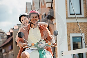 excited interracial couple in hardhats riding